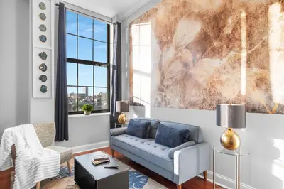 a living room with a couch and a chair at Sleek NoLibs 1BR - Pool & Gym in Philadelphia