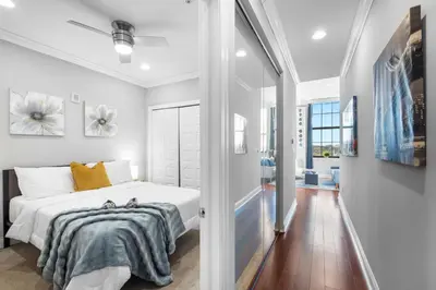 a white bedroom with a bed and a hallway at Sleek NoLibs 1BR - Pool & Gym in Philadelphia