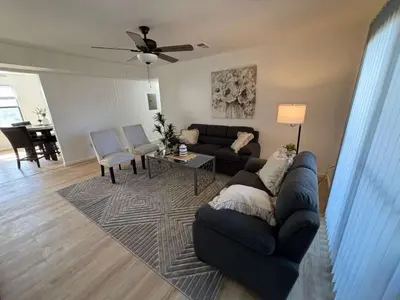 a living room with a couch and a table at Entire Cozy Apartment Fully Renovated Modern Style in North Brunswick