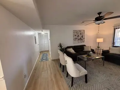 a living room with a couch and a table at Entire Cozy Apartment Fully Renovated Modern Style in North Brunswick