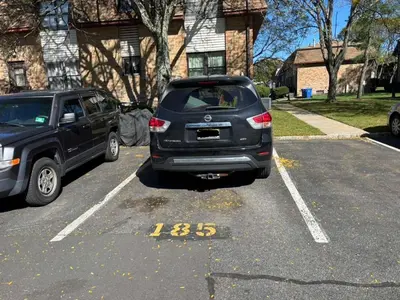 a car is parked in a parking lot at Entire Cozy Apartment Fully Renovated Modern Style in North Brunswick