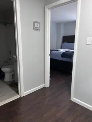 an open door to a bedroom with a bed and a toilet at Kickback and relax in Elizabeth