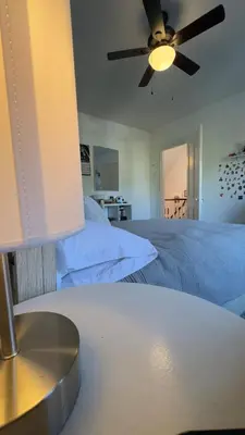 a bedroom with a bed and a ceiling fan at Bright & Spacious Home close to NYC and World Cup in Bayonne