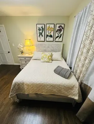 a bedroom with a bed with a white bedspread at The Princeton Three Cozy 3BR Retreat, BBQ Patio - Shared Home in Trenton
