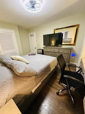 a bedroom with a bed and a desk and a chair at The Princeton Three Cozy 3BR Retreat, BBQ Patio - Shared Home in Trenton