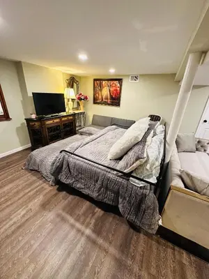 a bedroom with a large bed and a couch at The Princeton Three Cozy 3BR Retreat, BBQ Patio - Shared Home in Trenton