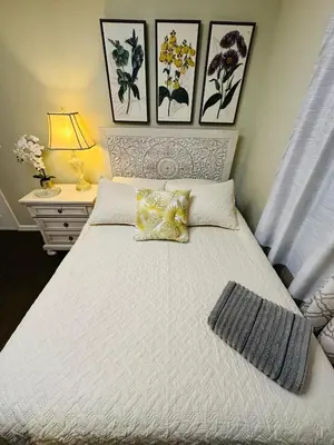 a bedroom with a white bed with two pillows at The Princeton Three Cozy 3BR Retreat, BBQ Patio - Shared Home in Trenton