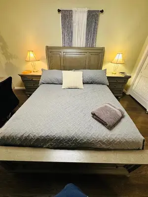 a bed in a bedroom with two lamps and two tables at The Princeton Three Cozy 3BR Retreat, BBQ Patio - Shared Home in Trenton