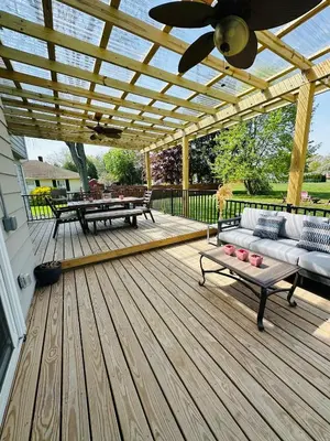 a wooden deck with a couch and a table at The Princeton Three Cozy 3BR Retreat, BBQ Patio - Shared Home in Trenton
