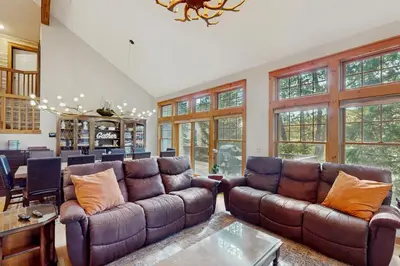 a living room with two brown leather couches and a table at Vista at Camelback Mountain in Tannersville