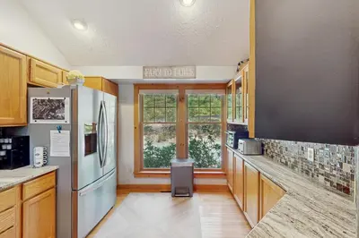 a kitchen with a refrigerator and a window at Vista at Camelback Mountain in Tannersville