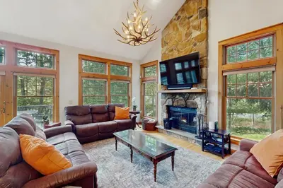 a living room with couches and a fireplace at Vista at Camelback Mountain in Tannersville