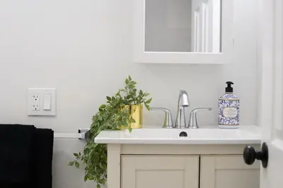 a bathroom with a sink and a mirror at 20 Mins to Times Sq. EWR | Cozy Apartment | Sleeps 4 in Jersey City