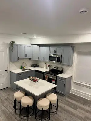 a kitchen with a table and stools in it at Cozy Retreat Near EWR with NYC access in Newark