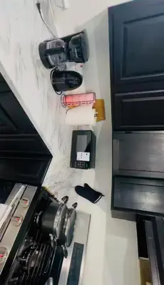 a kitchen counter with a stove top oven next to a microwave at Cozy Home 3BR-2Bath near EWR NYC DreamMall MetLife in Newark