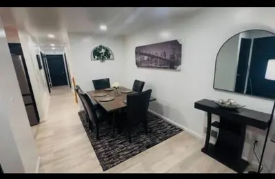 a dining room with a table and black chairs at Cozy Home 3BR-2Bath near EWR NYC DreamMall MetLife in Newark