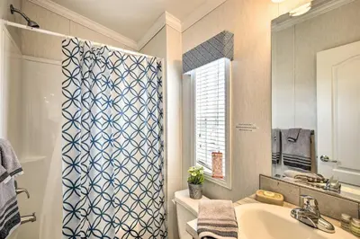 a bathroom with a sink and a shower curtain at Cottage and Suite Close to Camps and Ski Resorts in Pleasant Mount