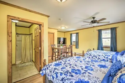 a bedroom with a bed and a dining room at Relaxing Premium Suite Near Ski Resort in Pleasant Mount