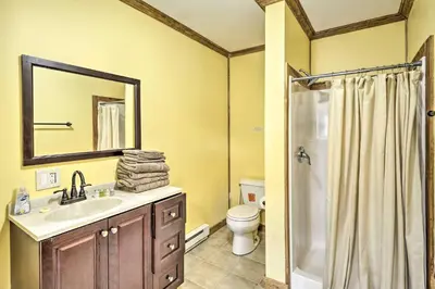 a bathroom with a sink and a toilet and a mirror at Relaxing Premium Suite Near Ski Resort in Pleasant Mount