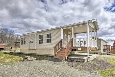 a small house with a porch and stairs on it at Country Escape Close to Ski Resort in Pleasant Mount