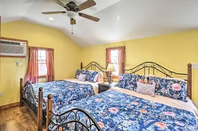 a bedroom with two beds and a ceiling fan at Gather, Celebrate, Unwind Close to Ski Trails in Pleasant Mount