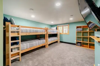 two bunk beds in a room with green walls at Ski-InandSki-Out Camelback Mtn Retreat with Hot Tub in Tannersville