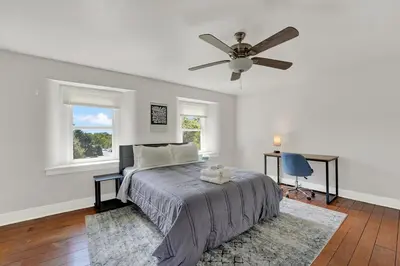 a bedroom with a bed and a ceiling fan at Spacious 5-Bed Retreat in Charming Kennett Square in Kennett Square