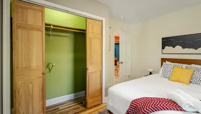 a bedroom with a bed and a green wall at Sleeps 13 Private Sauna Hot Tub Game Room in Thornhurst