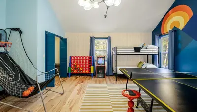 a living room with a ping pong table at Sleeps 13 Private Sauna Hot Tub Game Room in Thornhurst