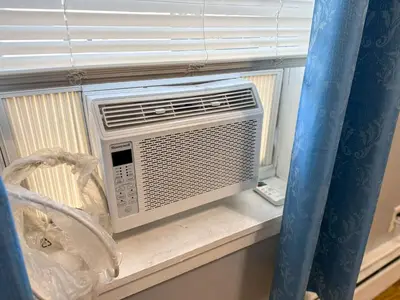 a air conditioner sitting on a window sill at New 3 BR Apt in Elizabeth Railroad Style Path Train Bus Hospital EWR Airport NJ Manhattan NYC in Elizabeth