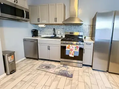 a kitchen with a stove and a refrigerator at New 3 BR Apt in Elizabeth Railroad Style Path Train Bus Hospital EWR Airport NJ Manhattan NYC in Elizabeth