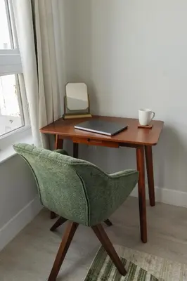 a desk with a laptop and a chair next to a window at Luxe Loft 15 Min from NYC with City View & Gym in Jersey City