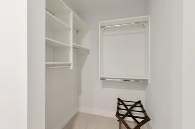 a room with white walls and a window and a chair at Sleek Loft 15 Min from NYC with Manhattan View in Jersey City