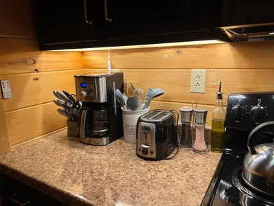 a kitchen counter with a coffee maker and a toaster at Mountain Bliss Cottage