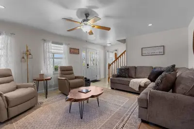 a living room with a couch and a ceiling fan at Peaceful Valley Retreat in Elliottsburg