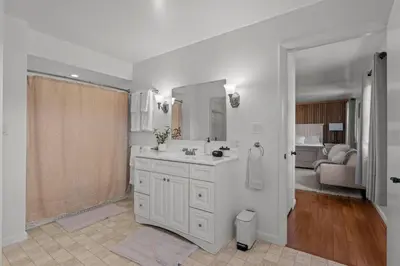 a white bathroom with a sink and a mirror at Peaceful Valley Retreat in Elliottsburg