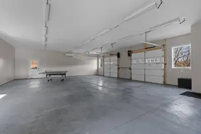 an empty garage with a ping pong table in it at Peaceful Valley Retreat in Elliottsburg