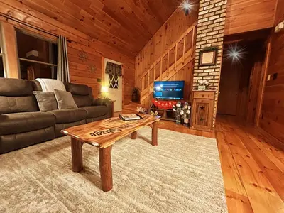 a living room with a couch and a coffee table at Pine View Cottage in Elliottsburg