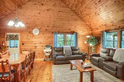 a living room with a table and a couch at Pine View Cottage in Elliottsburg