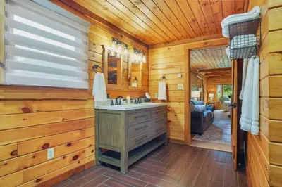 a bathroom with a sink in a log cabin at Ridgetop Cabin in Elliottsburg