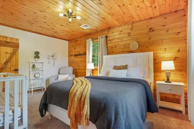 a bedroom with a bed and a wooden ceiling at Ridgetop Cabin in Elliottsburg