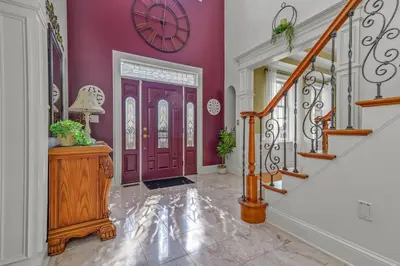 a purple hallway with a purple door with a clock on the wall at Willow Brook Mansion in Millerstown