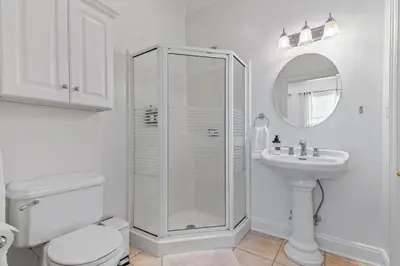 a white bathroom with a toilet and a sink at Willow Brook Mansion in Millerstown