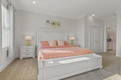a white bedroom with a bed and two night stands at Willow Brook Mansion in Millerstown