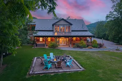 a house with a table and chairs in the yard at Grateful Acres Cabin
