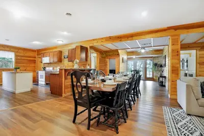 a dining room and kitchen with a table and chairs at Grateful Acres Cabin