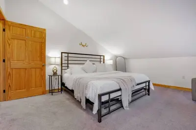 a bedroom with a large bed and a wooden door at Grateful Acres Cabin