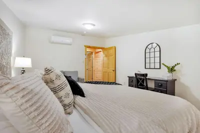 a bedroom with a white bed with pillows at Grateful Acres Cabin