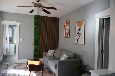 a living room with a couch and a ceiling fan at Cozy Home, 19m to NYC, 10m to American Dream in Wallington