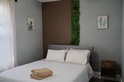 a bedroom with a bed with a towel on it at Cozy Home, 19m to NYC, 10m to American Dream in Wallington